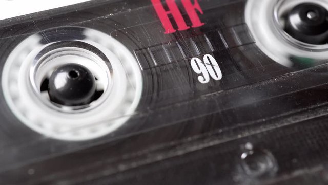 Retro audio tape copmact cassette is playing music.