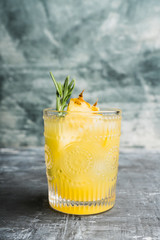 Old fahioned pineapple beverage on rustic background. Selective focus. Shallow depth of field.