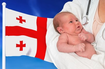Birth rate in Georgia. Newborn baby in hands of doctor.