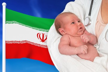 Birth rate in Iran. Newborn baby in hands of doctor.