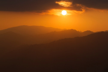 The sunset behind the mountains in winter.