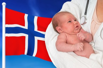 Birth rate in Norway. Newborn baby in hands of doctor.