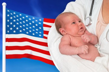 Birth rate in USA. Newborn baby in hands of doctor.
