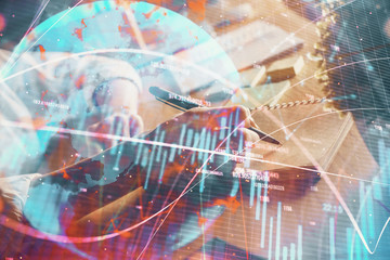 Financial forex charts displayed on woman's hand taking notes background. Concept of research. Double exposure