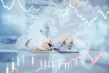 Financial chart drawn over hands taking notes background. Concept of research. Multi exposure