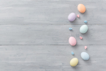 decorative easter eggs on a light wooden background. Easter-themed background with place for text
