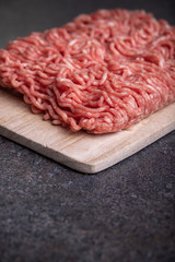 Minced Meat (Beef) as detailed close-up shot on dark background