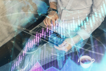 Fototapeta premium Forex graph with businessman working on computer in office on background. Concept of analysis. Double exposure.