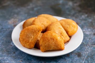 typical portuguese snack with meat rissois de carne on ceramic background