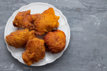typical portuguese Christmas sweets Sonhos on white dish on ceramic background
