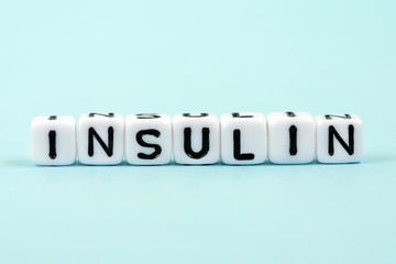 Insulin inscription on cubes. Medical blue background. Diabetes concept