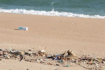 Plastic debris on the sand caused by human activities That is an environmental problem