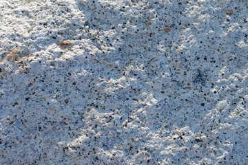 The surface of the white stone at the seashore Water eroded into a white background