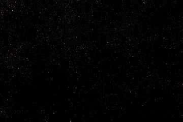 Red glitter bokeh lights on black background, unfocused. Holiday time. overlay layer