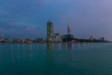 Naklejka premium Batumi, Adjara, Georgia. View from the sea on illuminated resort town at evening