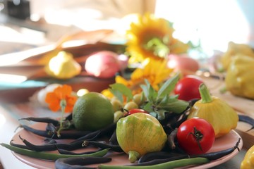 Bright fresh vegetables, fruits and flowers on a wooden table, healthy food