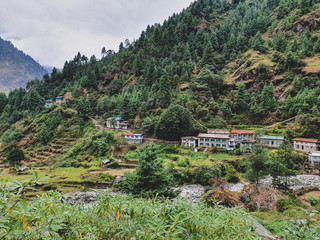 Everest base camp trek itinerary: way from Bupsa to Phakding, Beautiful views of Surke village nea Dhudh Kosi river, hills and mountains, Solokhumbu area, Nepal. - obrazy, fototapety, plakaty