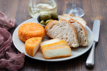 appetizer cheese with bread and olives on dish