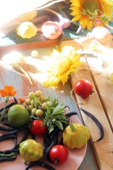 Bright fresh vegetables, fruits and flowers on a wooden table, healthy food