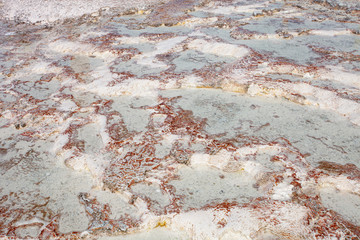 A fragment of travertine, available for visiting by tourists, in Pamukkale. Fragment of a unique natural landscape as a background.