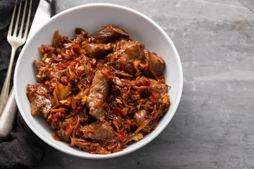 meat with vegetables in white bowl