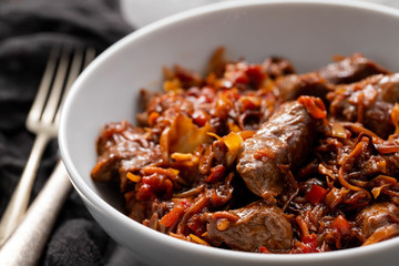 meat with vegetables in white bowl