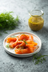 Smoked salmon with dill on a white plate