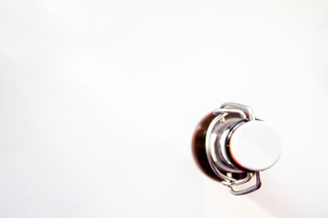 Closed glass bottle with a stopper on a metal latch. Place for your text. Top view