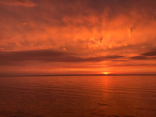 Fototapeta na wymiar Red orange fire sunset at the sea