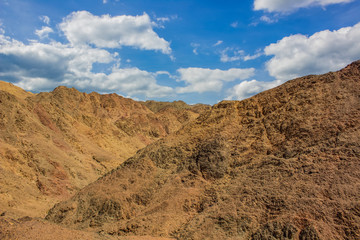 gorgeous picturesque desert landscape scenic view sand stone rocks wilderness environment with vivid blue sky white clouds background