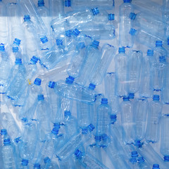 Blue plastic bottles, separate collection of garbage background backdrop. concept of the harm of plastic to the environment and the planet, environmental problems and pollution