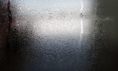 Water drops on the wet window glass. Abstract background.