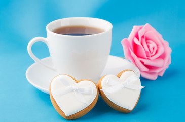 Heart-shaped cookies and a pink rose, a gift for Valentine's Day