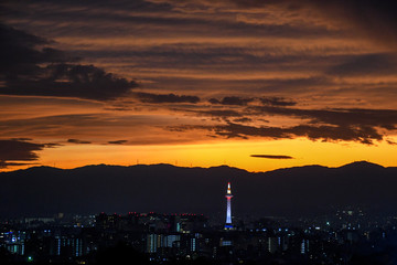 Fototapeta na wymiar Colorful Kyoto Tower at night with Kyoto city skyline