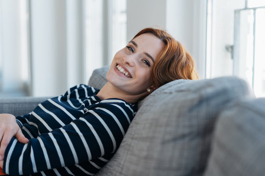Pretty young woman relaxing and smiling at camera