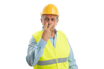 Construction worker pointing fingers at eyes