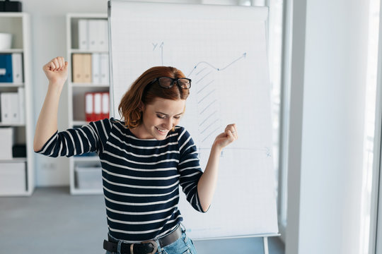 Jubilant young businesswoman rejoicing