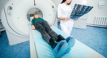 Model women doctor examine CT Scan picture