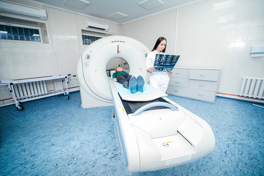 Model women doctor examine CT Scan picture