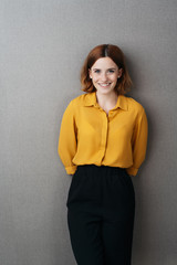 Attractive young woman posing on a grey background