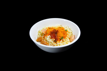 Dry instant noodles in a white cup in a black background