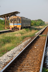 Obraz premium The train runs on rails in the suburbs. Train routes serve goods and people for a long time and are still popular.