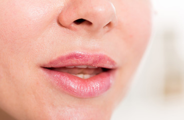 Close-up of female's lips with natural lipstick make up. macro lipgloss make-up