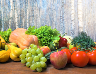 Fresh crop of fruits and vegetables on a wooden table.