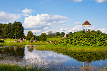 Obraz premium Park wih sculptures and pond near St. Anne's Church in Mosar, Belarus, the site of the Jesuit mission