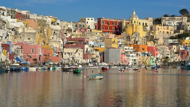 Colourful small italian fisherman village near Naples. Panning shot of Corriccella village in Procida island. Italy, Naples. 4K
