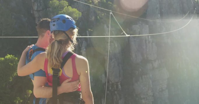 Young Caucasian couple in zip lining equipment