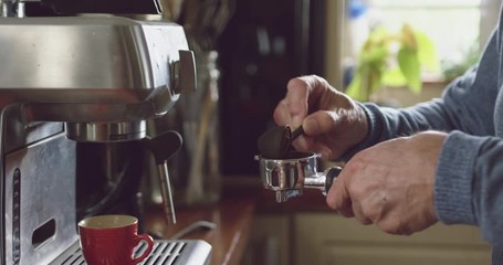 Senior man making coffee at home - Powered by Adobe