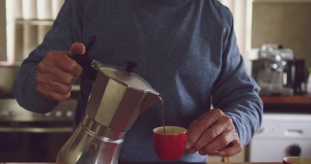 Senior man drinking coffee at home