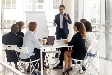 Male coach make whiteboard presentation for diverse employees